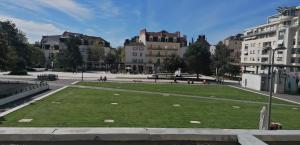 a park in the middle of a city with buildings at Appart cœur de ville belle vue in Vichy