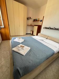 a bedroom with a bed with two towels on it at Glitter Home in La Spezia +27 photos