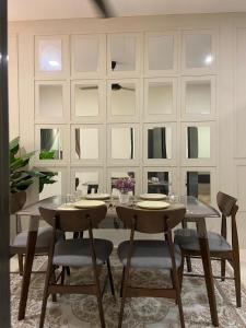 a dining room with a table and some chairs at Homestay Khan'Da Teluk Intan in Teluk Intan