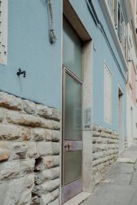 uma porta do lado de um edifício azul em Elegant Apartment 28 San Giacomo em Trieste