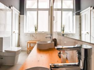 a bathroom with a sink and a toilet and windows at Bayview Two Bedroom St Georges Bay with free parking in St. Julianʼs +26 photos