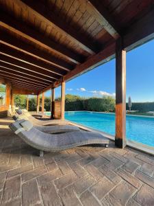 a bed on a patio with a view of a pool at Porsenna Resort in Villastrada