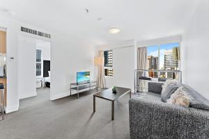 a living room with a couch and a table at AirCabin - Sydney CBD - Best Location -1 Bed Apt in Sydney