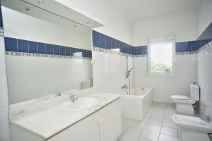 biała łazienka z umywalką i toaletą w obiekcie Sara Chambre d'hôtes w Antananarywie