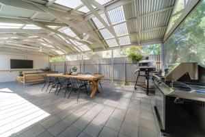 an outdoor patio with a table and chairs at The Grape Escape Location and style on Shiraz Trail in McLaren Vale