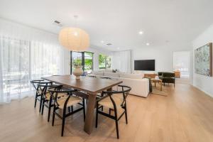 a living room with a table and a couch at The Grape Escape Location and style on Shiraz Trail in McLaren Vale