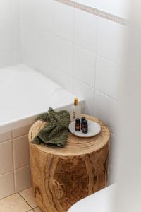 a bathroom with a wooden stump table with a sink on it at The Grape Escape Location and style on Shiraz Trail in McLaren Vale +35 photos