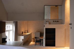 a small kitchen with a sink and a counter at Luxe in Het Posthuis - nieuwe Stijlvolle Verblijven in Oud-Rekem in Lanaken