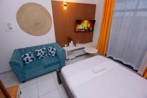 a small room with a couch and a television at BALI bamburi lakeview oasis in Mombasa