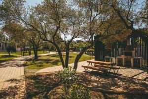 a park with a picnic table and a tree at Maistra Camping Amarin Pitches in Rovinj +26 photos