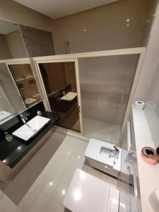 a bathroom with a white sink and a mirror at Luxurious appartement in Marrakech with Pool&Golf PRESTIGIA AMBRE in Marrakesh