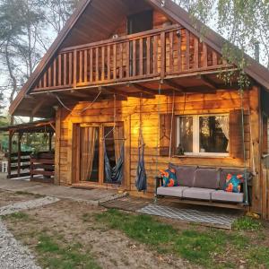 a log cabin with a couch in front of it at Dream Forest Cabin in Warsaw