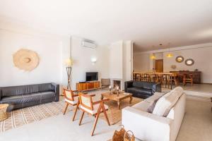 a living room with a couch and a table at Villa Gale Grande - bright airy property with a private pool in Albufeira