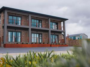 a large brick building with windows on the side of it at White Sands Self-catering units in Wilderness