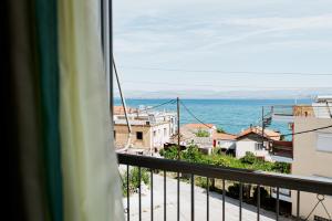 a view of the ocean from a balcony at Mavromati Rooms in Kivérion