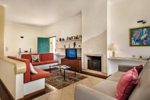 a living room with a couch and a fireplace at Villa Almanda - Spacious villa perfectly located between Albufeira Marina and the Old Town in Albufeira