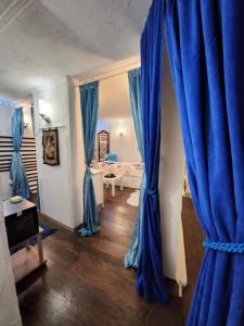 a room with blue curtains and a room with a bed at Spa center Apartment Belgrad in Brestovik