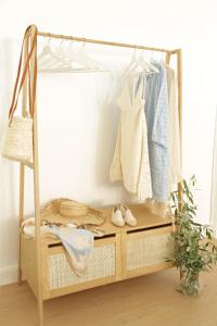 a clothes rack with clothes and shoes in a room at D’oude Dune in Nieuwpoort
