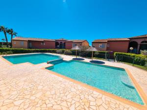 a swimming pool in a yard with anergy at 3 pièces entre mer et nature - Les Clés de l'Esterel in Théoule-sur-Mer +15 photos
