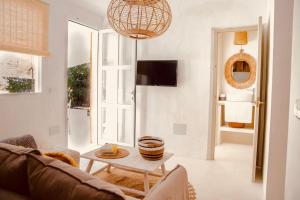 a living room with a couch and a table at Can Sorra - Modern & Stylish Villa in Sant Ferran de Ses Roques