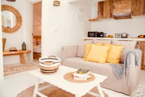 een woonkamer met een bank en een tafel bij Home / Rural Modern House in Sant Ferran de Ses Roques