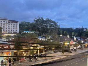 a city street with people walking on the sidewalk at HẢI ANH in Da Lat