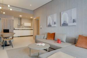 a living room with a couch and a table at Pestana Casablanca, Seaside Suites & Residences in Casablanca