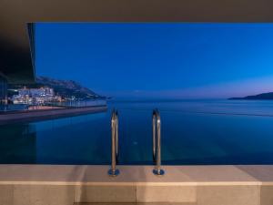 a swimming pool with a view of the water at Sea Star Budva in Budva