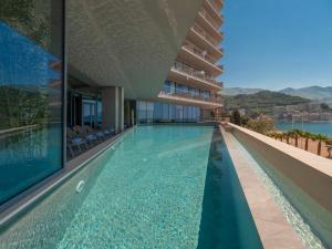 a swimming pool on the side of a building at Sea Star Budva in Budva