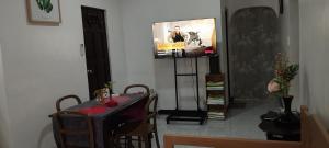 a dining room with a table and a tv on a wall at 11 Guest - Unit 3 in Santa Rosa