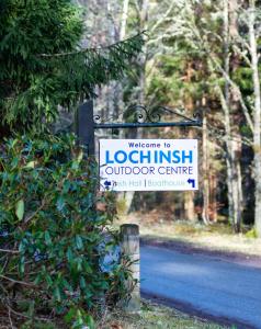 a sign for aolkien outdoor centre on a road at Insh Hall in Kincraig