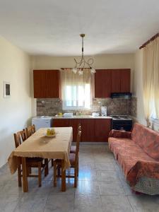 a living room with a table and a couch at Εξοχικό με θέα στον Όλυμπο in Skotina
