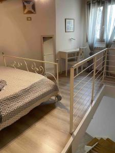 a bedroom with a bed and a staircase with a mirror at Il mio posto ai Quattro Canti - Centro storico Palermo in Palermo