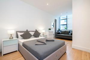 a bedroom with a bed and a living room at Camden Town Apartments in London