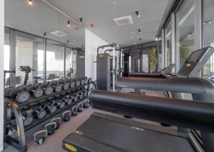a gym with rows of treadmills and machines at Sea Star Budva in Budva