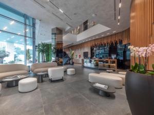 a lobby with couches and chairs in a building at Sea Star Budva in Budva