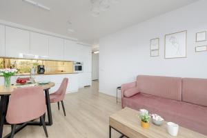 a living room with a couch and a table at Stylish Apartment with Balcony and Garage in Świnoujście by Renters in Świnoujście