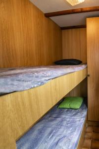 two bunk beds in a cabin with a green pillow at Domki Letniskowe in Nielisz