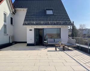 een patio met 2 stoelen en een tafel en een gebouw bij Gästehaus Stoll in Filderstadt