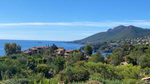 a town on a hill with a lake and mountains at 3 pièces entre mer et nature - Les Clés de l'Esterel in Théoule-sur-Mer
