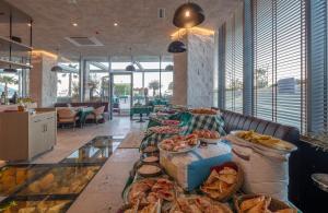 a buffet line with many different types of bread and pastries at Sea Star Budva in Budva