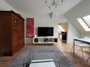TV a/nebo společenská místnost v ubytování 1 Ferienwohnung - Ferien Mittendrin