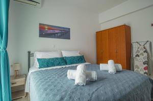 A bed or beds in a room at Basiliki's Apartments