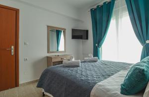 A bed or beds in a room at Basiliki's Apartments