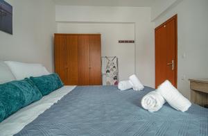 A bed or beds in a room at Basiliki's Apartments