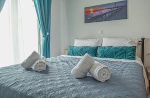 A bed or beds in a room at Basiliki's Apartments
