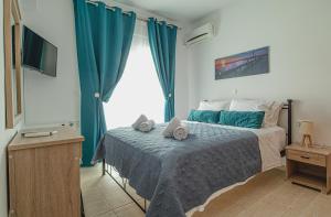 A bed or beds in a room at Basiliki's Apartments