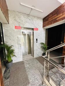 a lobby of a building with a stone wall at Hotel Royal Orbit in Dehradun