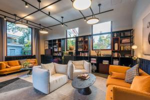 a living room with two couches and a table at Leliving Butterfly Resort Lijiang in Lijiang