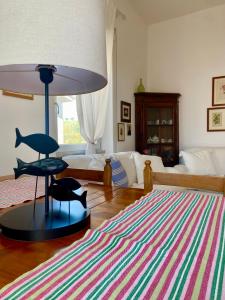 a living room with a large lamp and a rug at Family House in Santa Severa